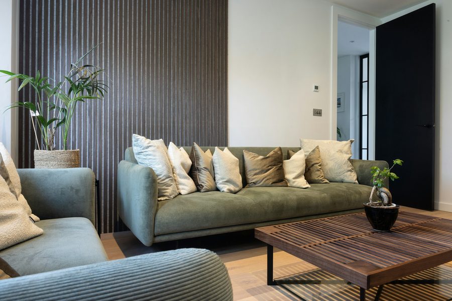 Contemporary living room with a fluted feature wall and layered neutral seating