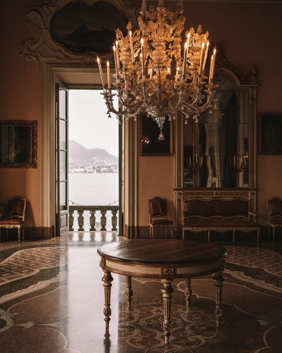 A warm, welcoming residential interior with a chandelier and richly patterned walls